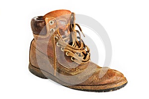 Single brown leather work boot on white
