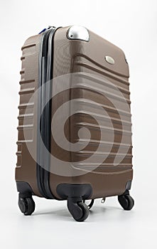Single brown polycarbonate luggage isolated on white background, clipping path. Travel zipper baggage with black wheels
