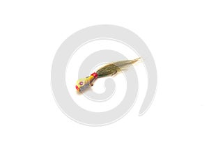Single bucktail Jig head lure with hydrodynamic head, oversized painted eyes and deer hair isolated