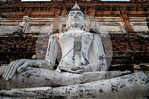 single Buddha statue inside Wat Yai Chai Mongkhon, a Buddhist temple of archaeological park photo