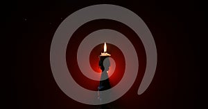 Single burning candle. Light of flame and flowing candle wax, dark background. Slider shot