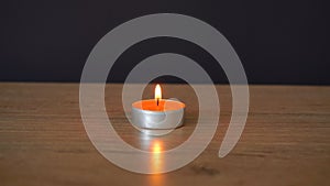 single candle burns on the table