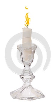 Single candle with flame in candlestick