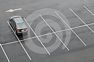 Single car in empty parking lot photo