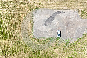 Single car on empty parking lot. aerial view