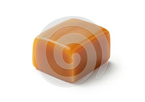Single caramel candy cube isolated on white background