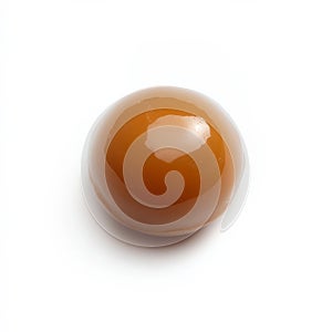 A single caramel candy with a smooth texture, isolated on a white background, showcasing a classic