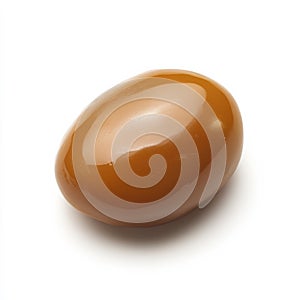 A single caramel candy with a smooth texture, isolated on a white background, showcasing a classic