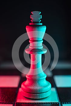 Single chess king. Good or bad side. Red and blue light