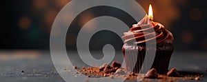 Single chocolate cupcake, single burning candle , candle, baking