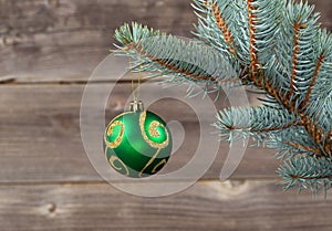 Single Christmas Ornament hanging from Blue Spruce Branch