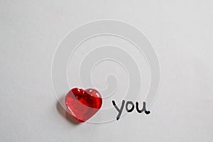 Single clear red heart on white background with handwritten note