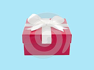 single closed red gift box with white ribbon bow isolated on blue background