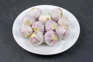 Single clove garlic on grey stone