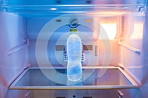 Single cold water bottle on a shelf in refridgerator