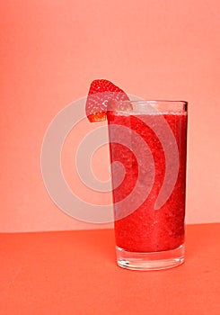 Single-color opaque cocktail, orange, red refreshing in a jug with ice cubes with the taste of tomato, grapeprut, strawberry. Side