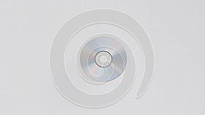 Compact Disc with Rainbow Reflection on White Background