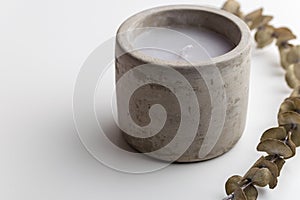 Single concrete candle with essential oils. Minimalism concept