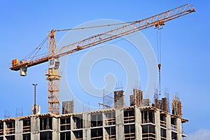 Single construction crane at the construction of monolithic apartment building