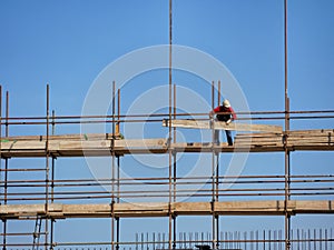 Single construction worker on construction site scaffolding