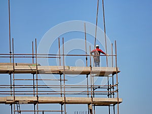 Single construction worker on construction site scaffolding