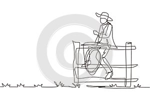 Single continuous line drawing American cowboy with lasso rope on wild west sunset landscape in the evening. Cowboy lifestyle in
