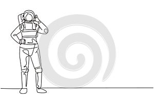 Single continuous line drawing female astronaut stands with call me gesture wearing spacesuit exploring earth, moon, other planets