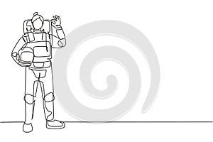 Single continuous line drawing female astronaut stands with gesture okay wearing space suit exploring earth, moon, other planets