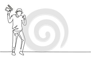 Single continuous line drawing film director stands with celebrate gesture holding clapperboard and prepare camera crew for