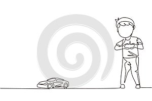 Single continuous line drawing little boy playing with remote-controlled car. Cute kids playing with electronic toy car with