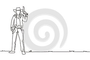 Single continuous line drawing smart cowboy with hat holding his gun. American gunslinger style holding gun concept. Weapons for