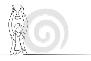 Single continuous line drawing young businesswoman wearing blazer holding up golden trophy with both hands. Symbol of achievement