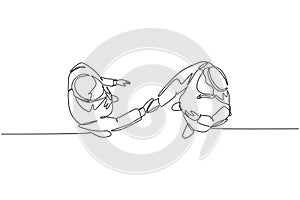Single continuous line drawing of young happy muslim business man handshake his partner top view. Arab middle east businessmen photo
