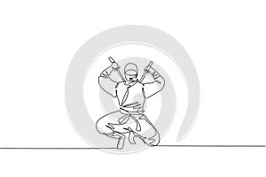 Single continuous line drawing of young Japanese culture ninja warrior on mask costume with attacking stance pose. Martial art