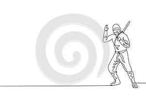 Single continuous line drawing of young Japanese culture ninja warrior on mask costume with attacking stance pose. Martial art