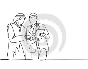 Single continuous line drawing of young muslim analyzing and discussing annual business report with his colleague. Arab middle