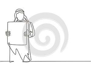 Single continuous line drawing of young muslim businessman showing white paper board to audience. Arab middle east cloth shmagh, photo