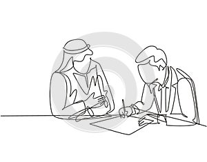 Single continuous line drawing of young muslim sign a business deal agreement contract with his colleague. Arab middle east cloth photo