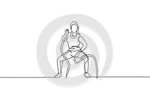 Single continuous line drawing of young sportive woman training with battle rope in sport gymnasium club center, front view.