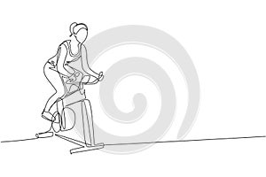 Single continuous line drawing of young sportive woman training endurance with static bike in sport gymnasium club center. Fitness