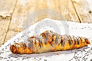 Single croissant on doily