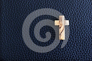 Cross on black leather background