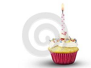 Single cup cake with lit pink spotted candle isolated on white b