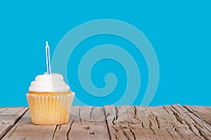 Single cupcake with blue candle