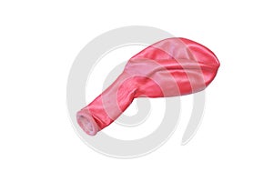 Single deflated decorative red balloon isolated on white background.