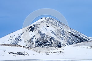 Single dramatic symetrical volcanic,snow covered cone near lake Myvatn, Iceland in mid winter