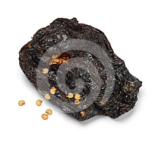 Single dried raw Mexican Ancho pepper on white background close up photo