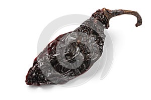 Single dried smoked Mexican chipotle pepper on white background close up