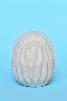 Easter egg with honeycomb pattern on blue background