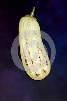 Single eggplant slice isolated on dark plain background